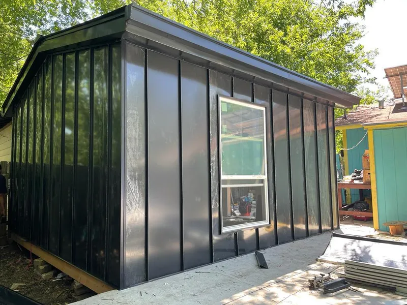 Black standing seam metal wall panels for Roof Inspection in Perryton