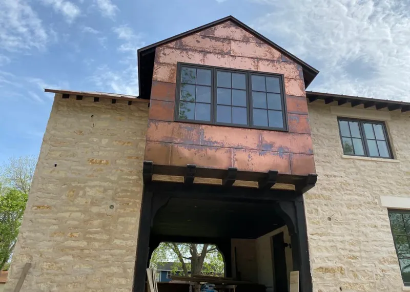 Copper metal panel facade on a stone building for Roof Repair in Perryton