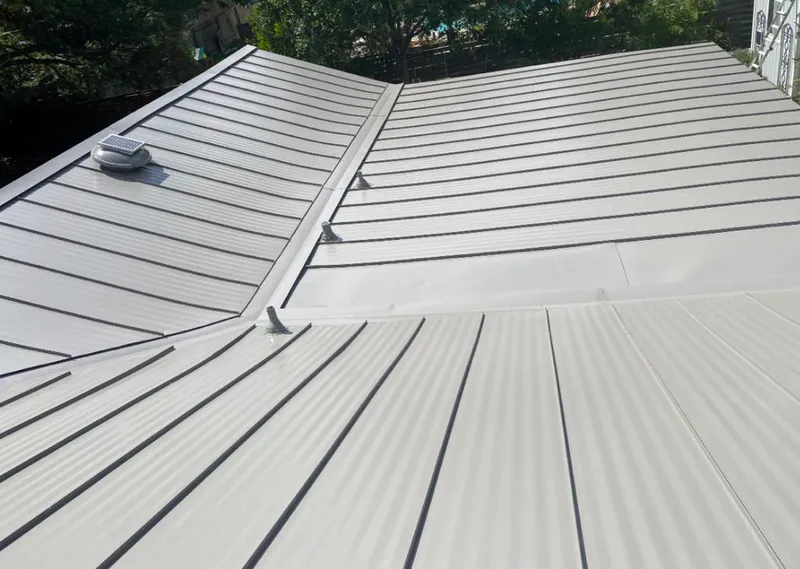 Solar attic fan installed on a metal roof for Roof Ventilation in Perryton